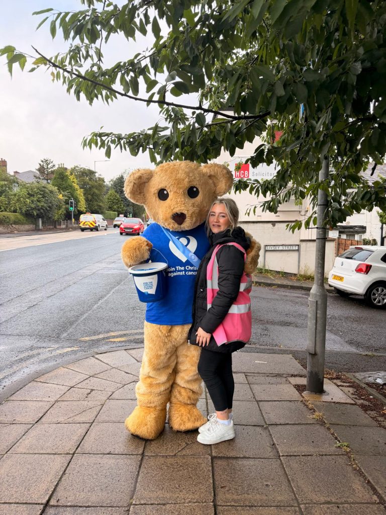 Christie teddy and a volunteer